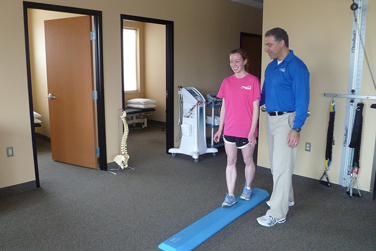 Girl doing a balance exercise at Pro-Motion Physical Therapy